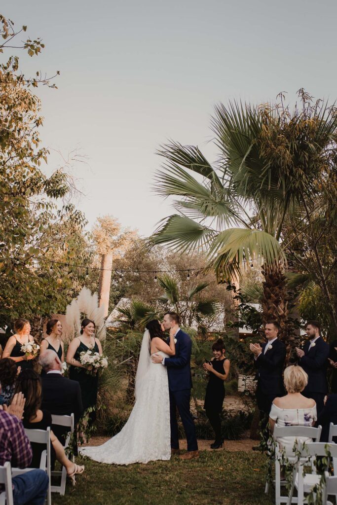 A couple kisses at their wedding ceremony in San Antonio, TX