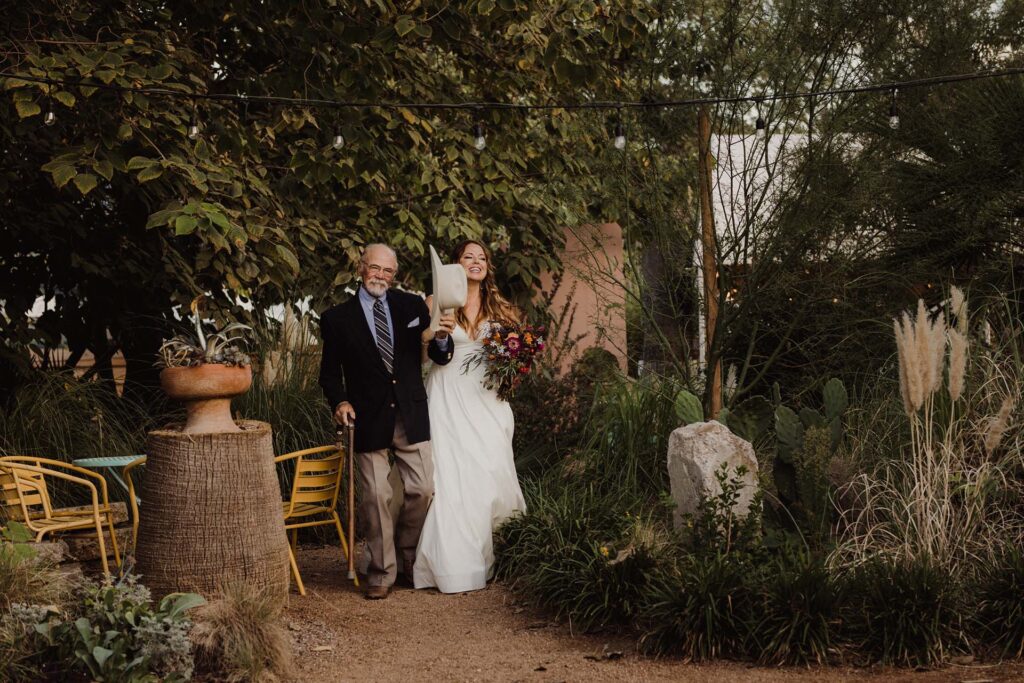A father walks his daughter down the aisle at a wedding venue in San Antonio, TX