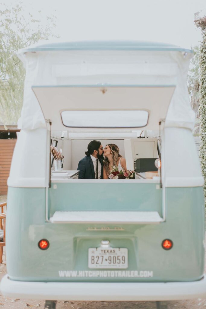 A couple gets their photo taken inside a trailer at Ivy Hall Events